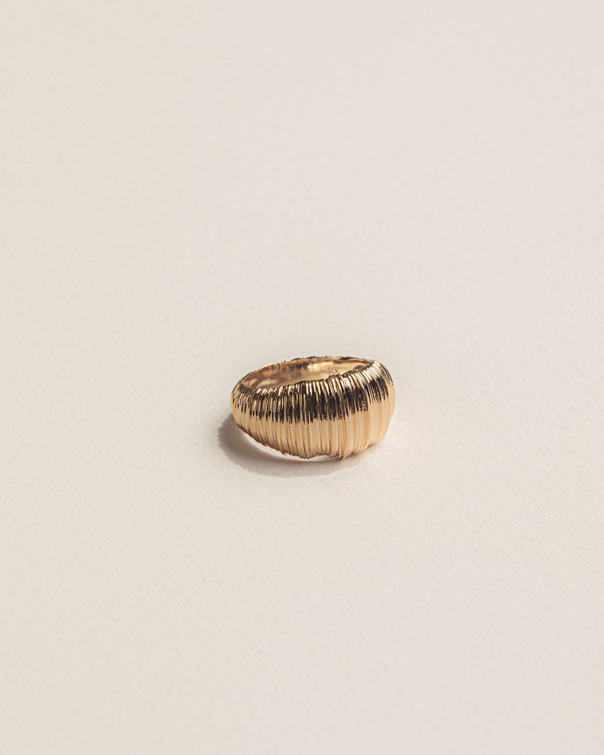 A 18k gold-plated ring representing a sand dune