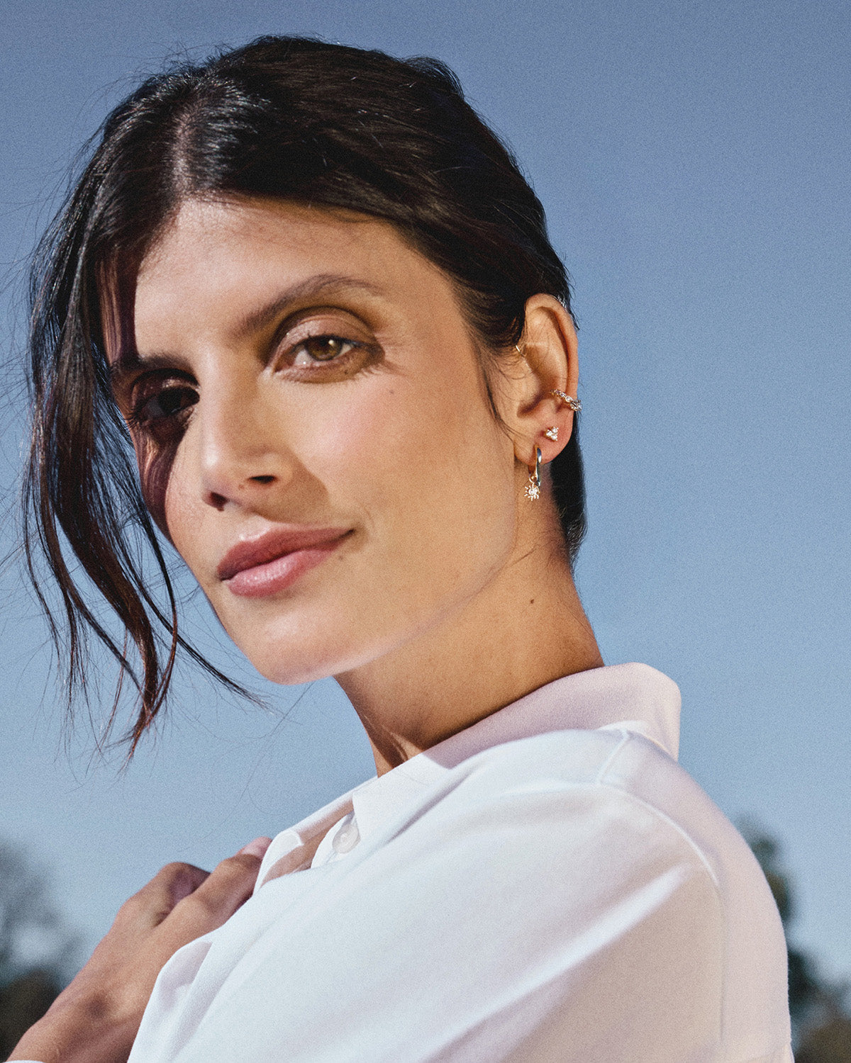 Three 18k gold-plated earcuffs on a model