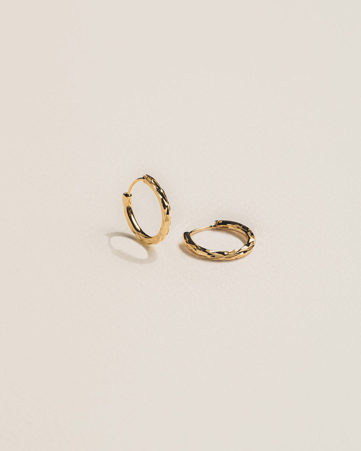 A 18k gold-plated pair of twisted hoop earrings.
