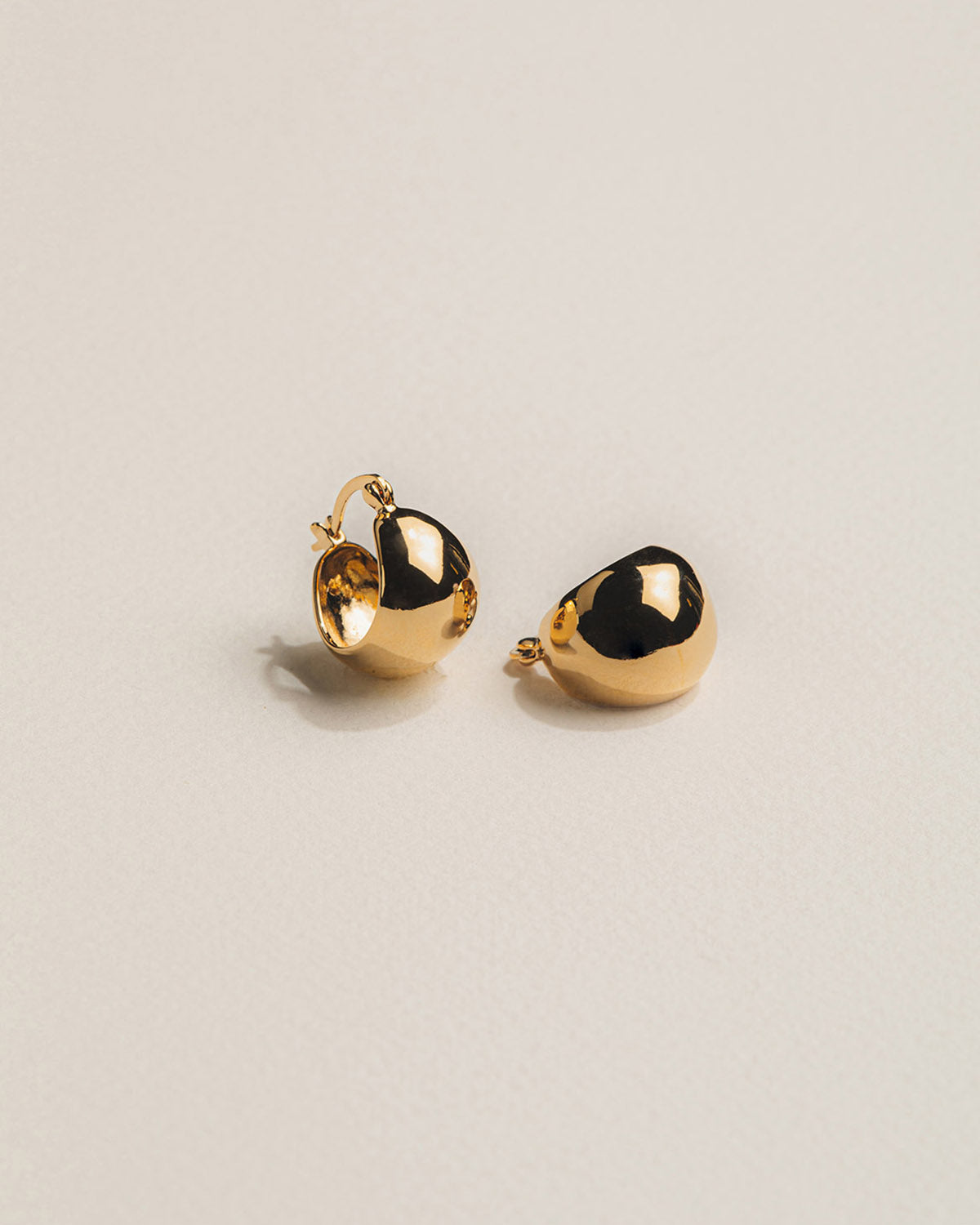 A pair of 18k gold-plated hoop earrings with a polished finish.