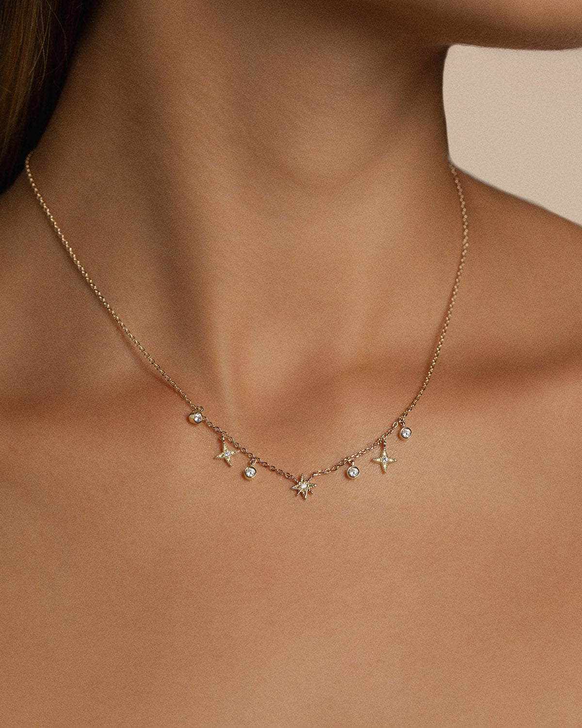 A 18k gold-plated charms necklace with stars shape.