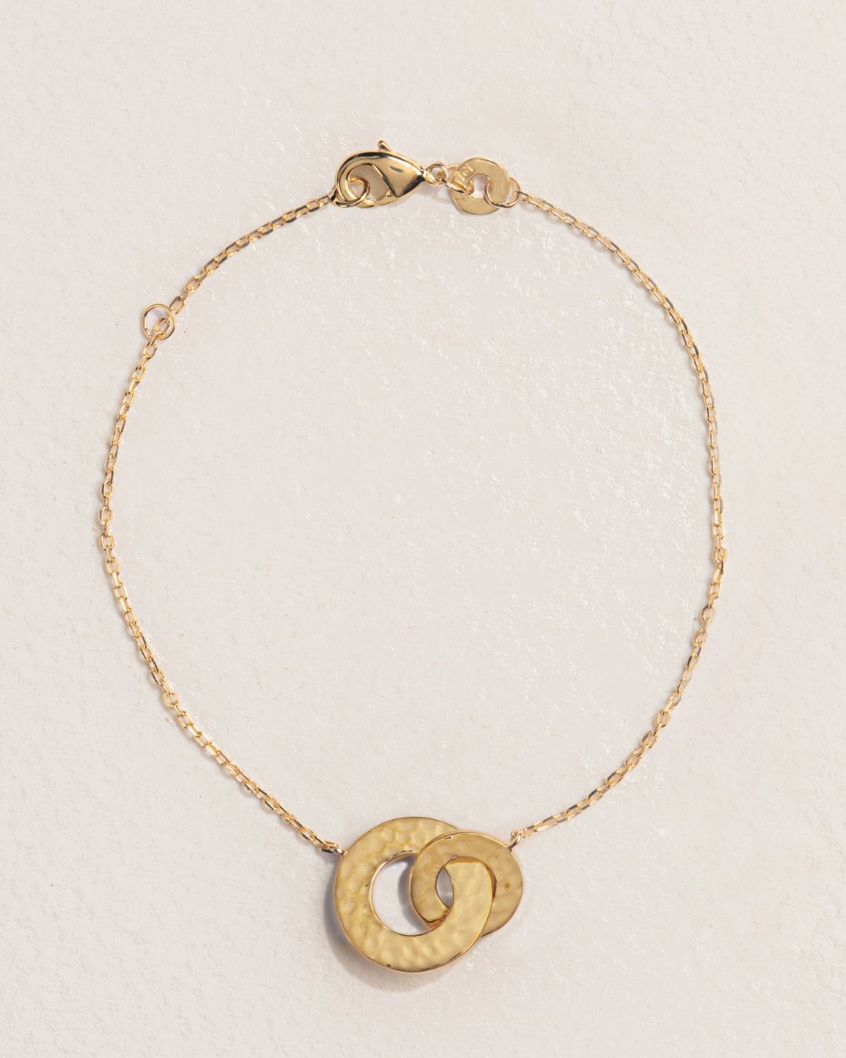 A 18k gold-plated bracelet with two textured circles as a central element.