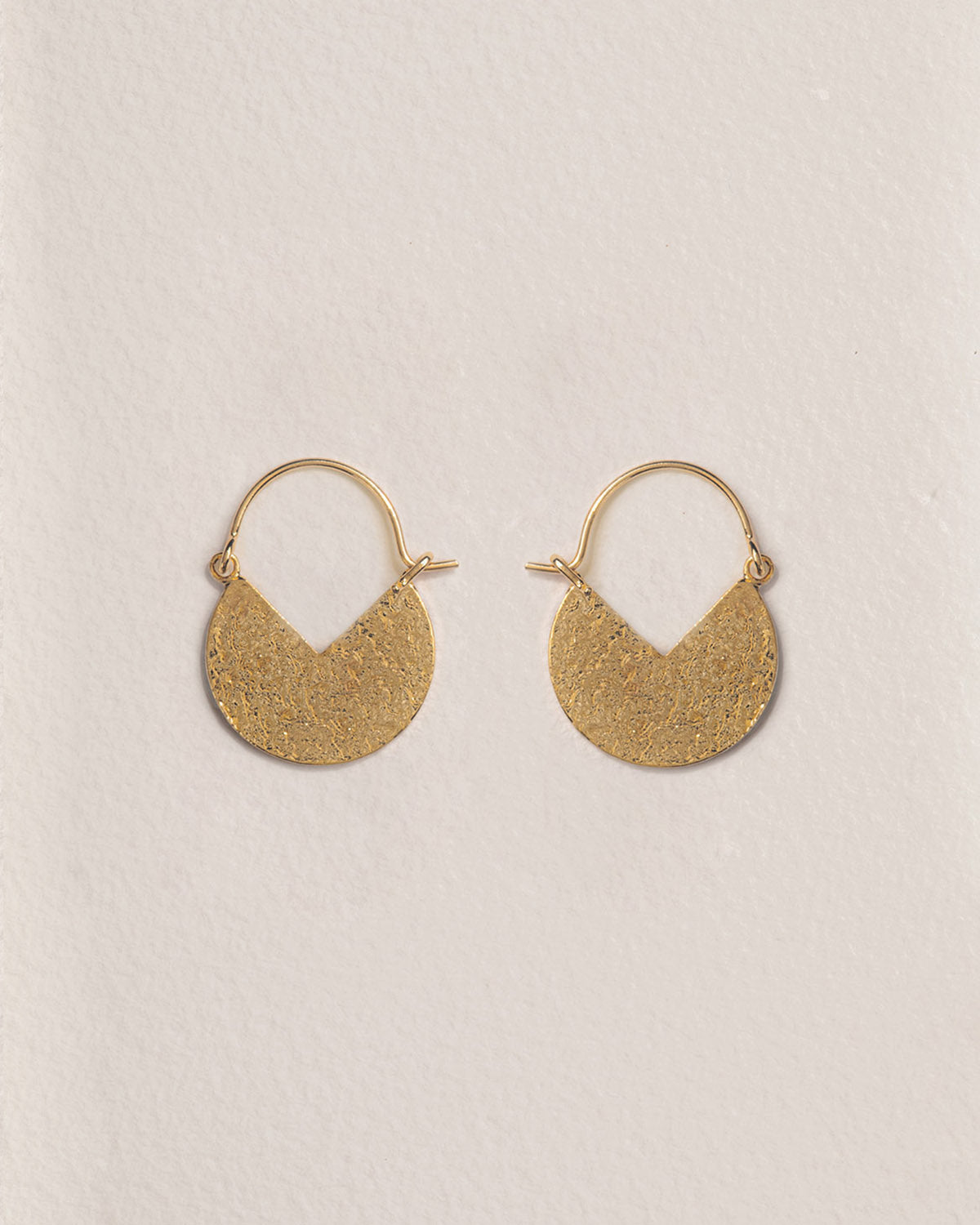 A 18k gold-plated pair of colored, hammered texture, half-moon earrings.