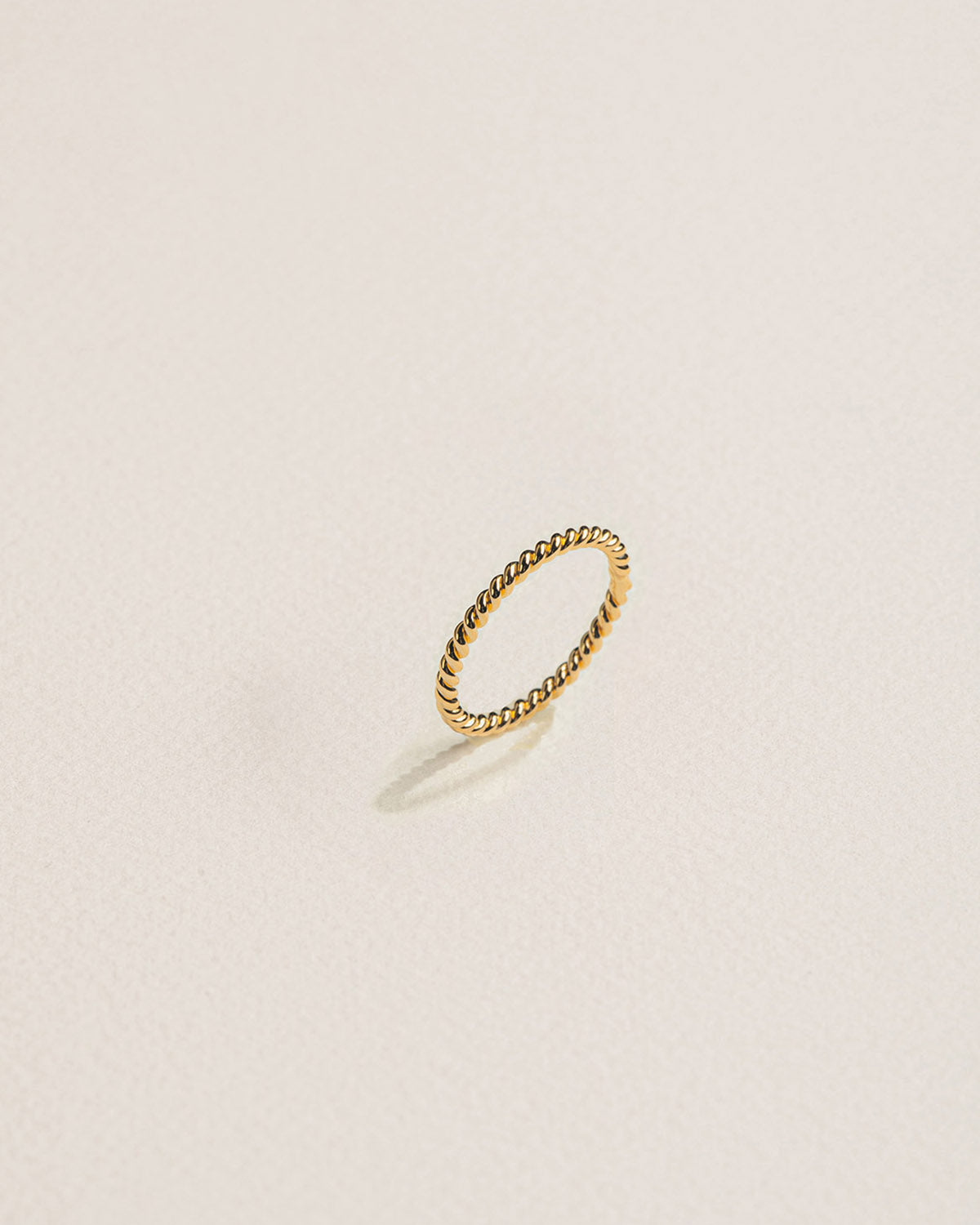 A 18k gold-plated twisted band ring.