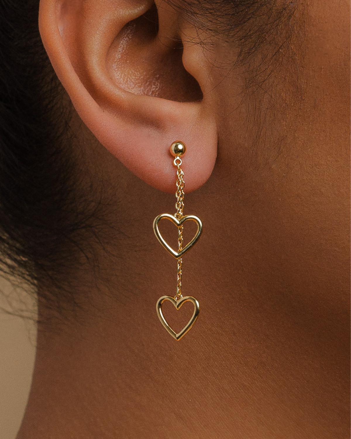 A 18K Gold-plated earrings pair suspended by two hearts