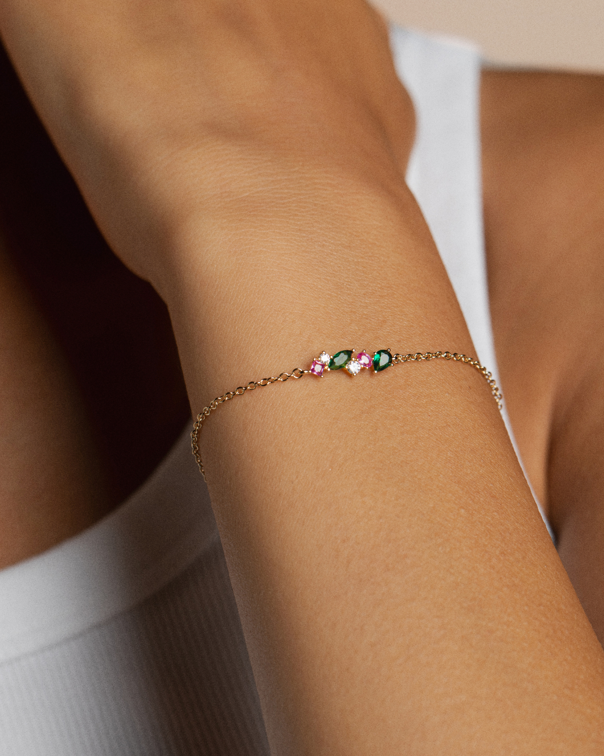 18k gold-plated bracelet with colorful beads zirconias: pink and green on a wrist