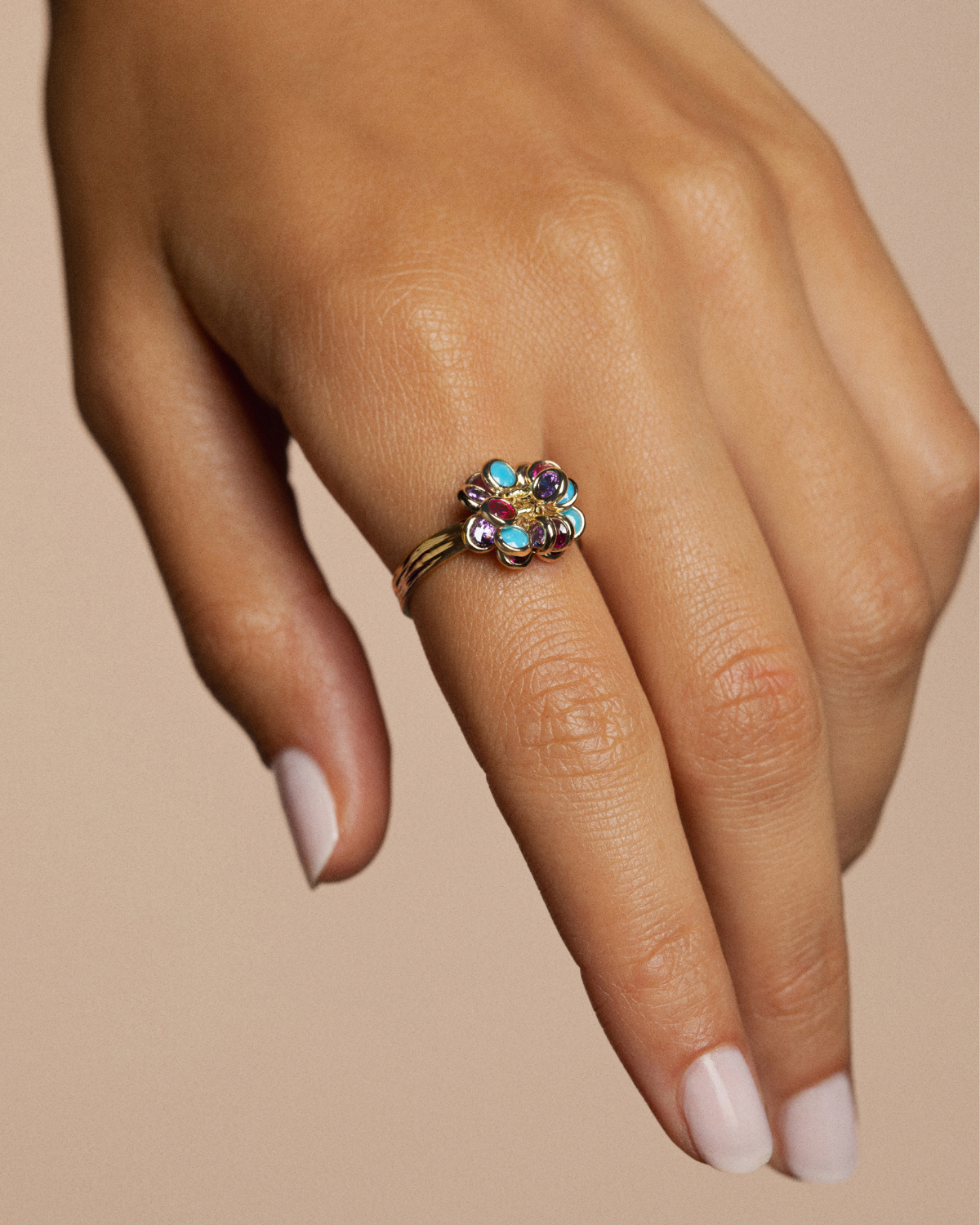 Hand wearing a colorful ring 