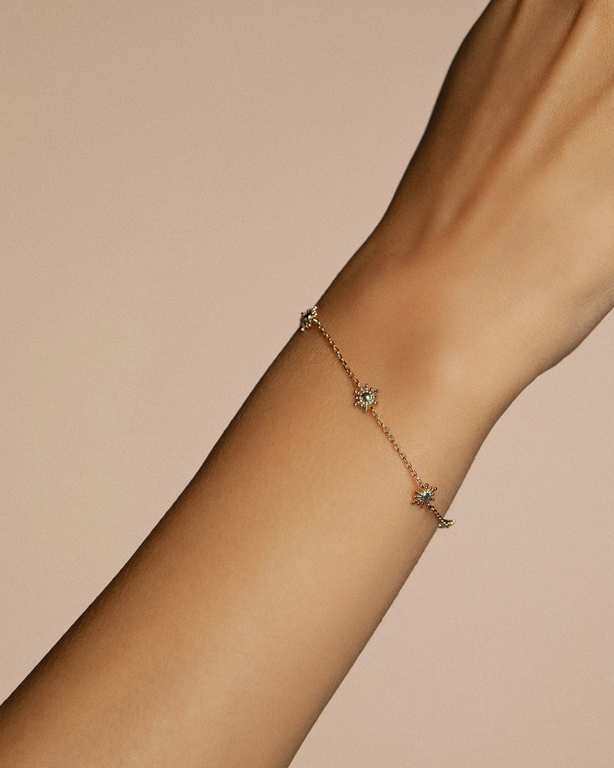 A 18k gold-plated solar bracelet on a fine chain