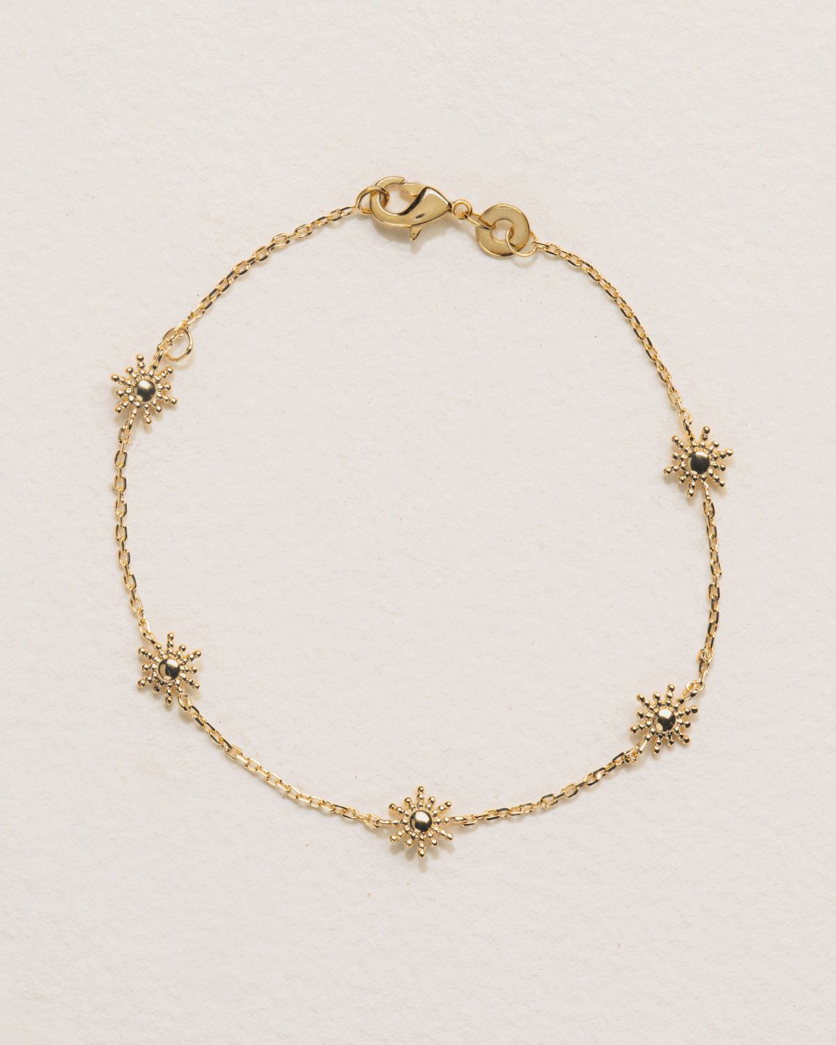 A 18k gold-plated colored bracelet with celestial charms, resembling a chain of stars