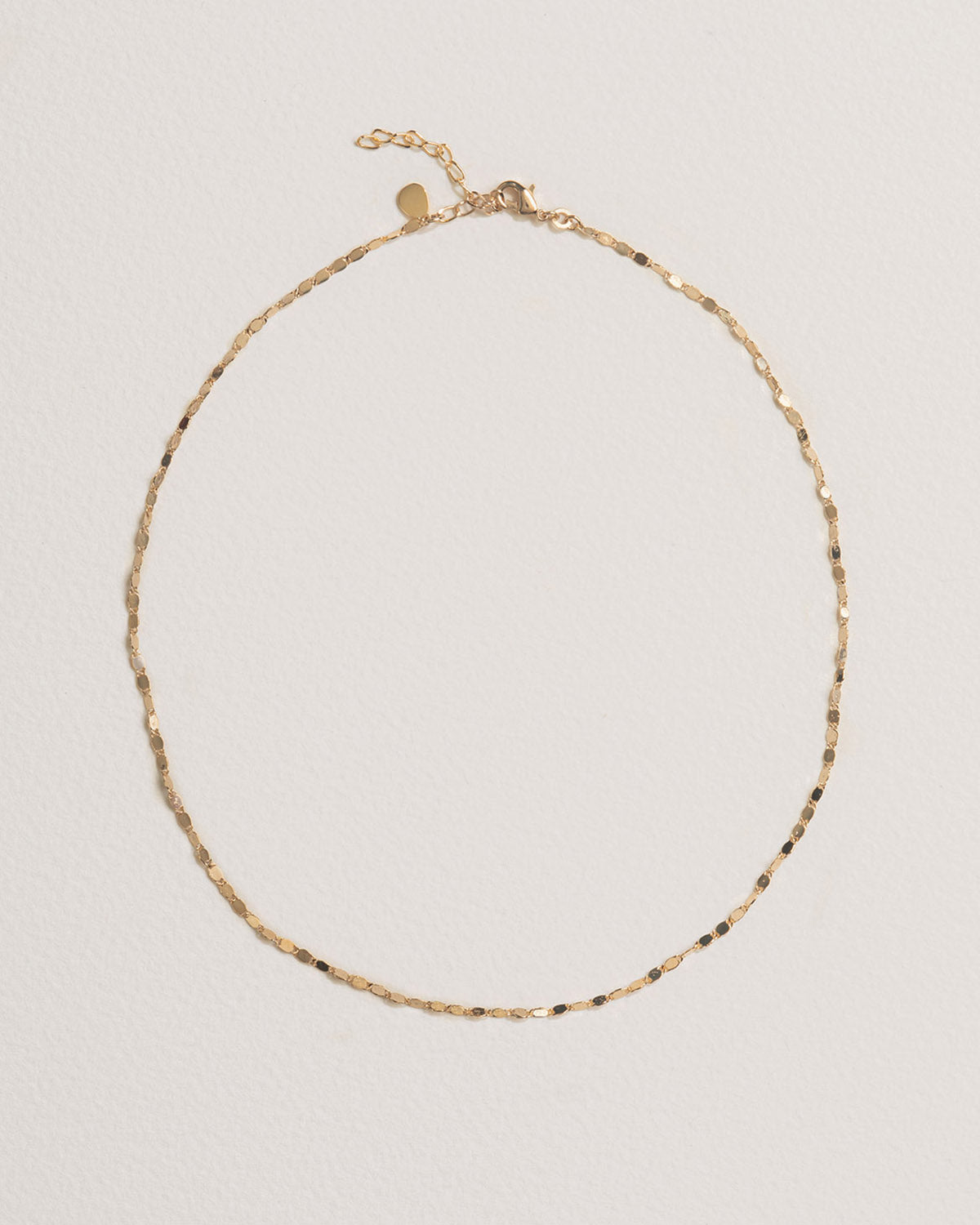 A 18k gold-plated necklace with delicate flat links and a fine chain structure.